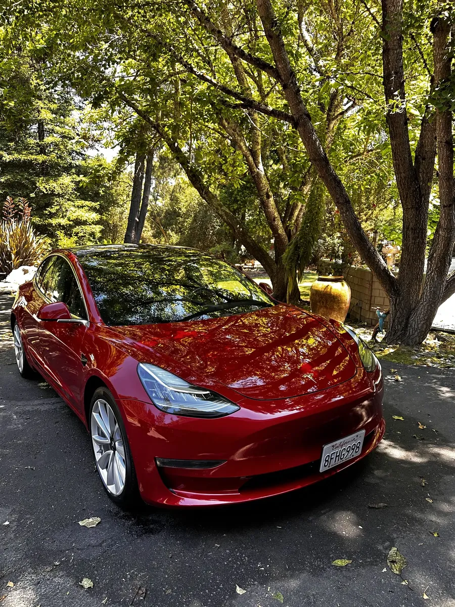 red Tesla Model 3 after an exterior detailing service