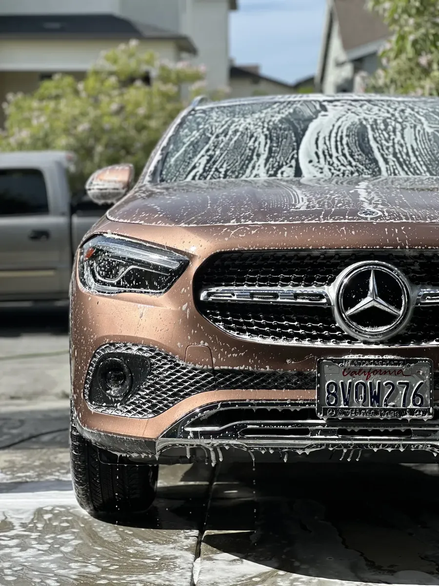 SUV covered in suds during an exterior hand wash detail